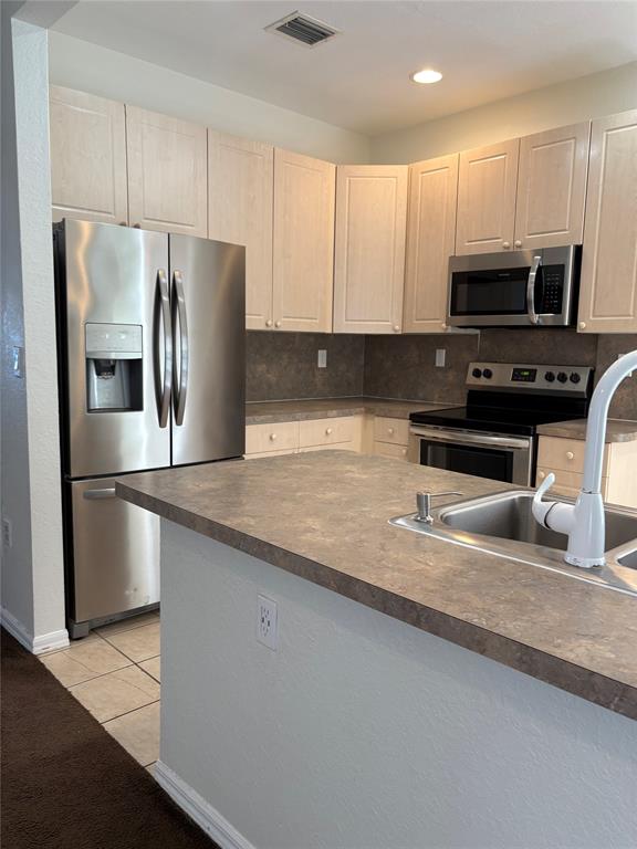 3533 Merrick Lane Margate, FL 33063 - Photo 3 of 14 a kitchen with stainless steel appliances granite countertop a refrigerator a stove and a sink with wooden floor