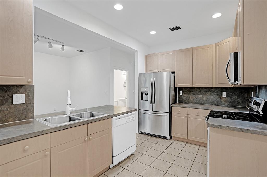 3533 Merrick Lane Margate, FL 33063 - Photo 3 of 27 a kitchen with a sink and refrigerator