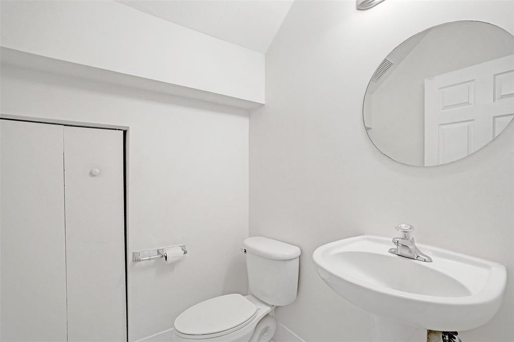 3533 Merrick Lane Margate, FL 33063 - Photo 9 of 27 a bathroom with a toilet a sink and mirror