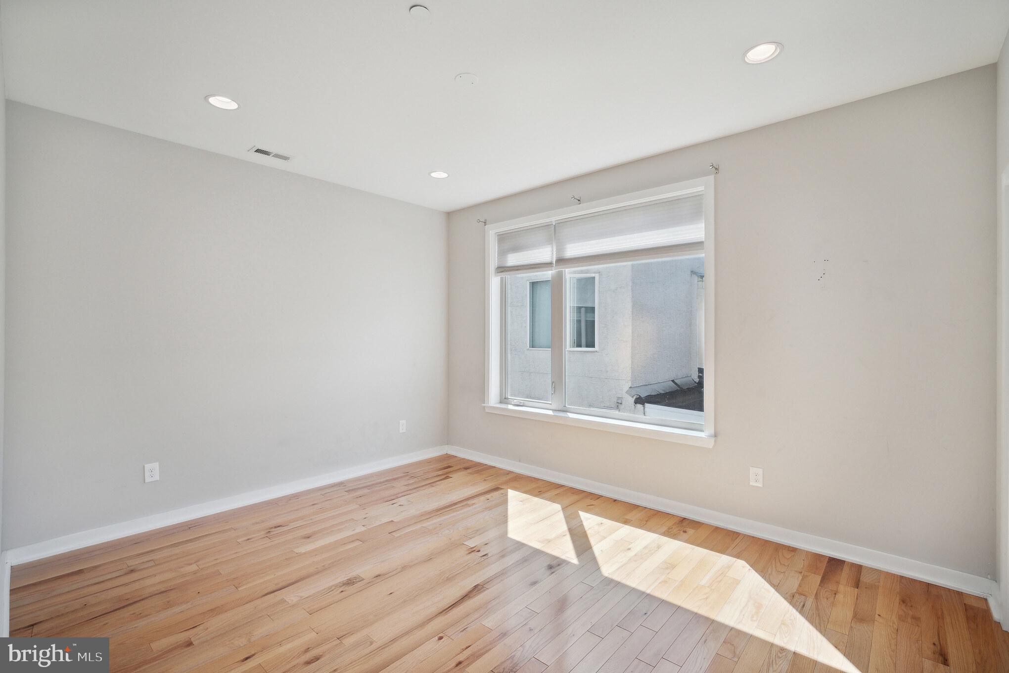 1246 East Fletcher Street Philadelphia, PA 19125 - Photo 15 of 29 a view of an empty room with wooden floor and a window