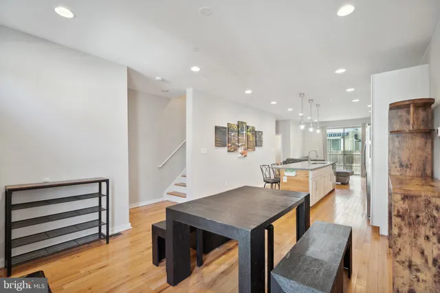 a dining room with furniture and wooden floor
