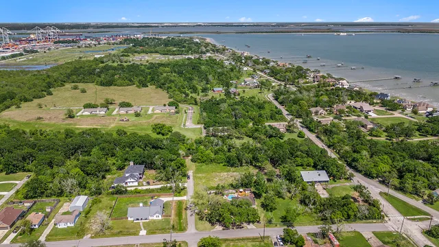 an aerial view of a residential apartment building with a yard and potted plants