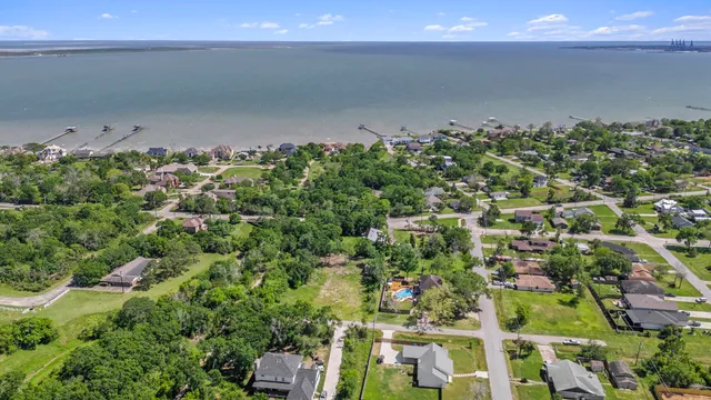 an aerial view of a residential houses with yard