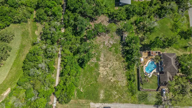 a view of a field with a trees in the background
