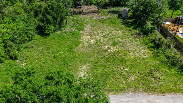 an aerial view of a house with a yard