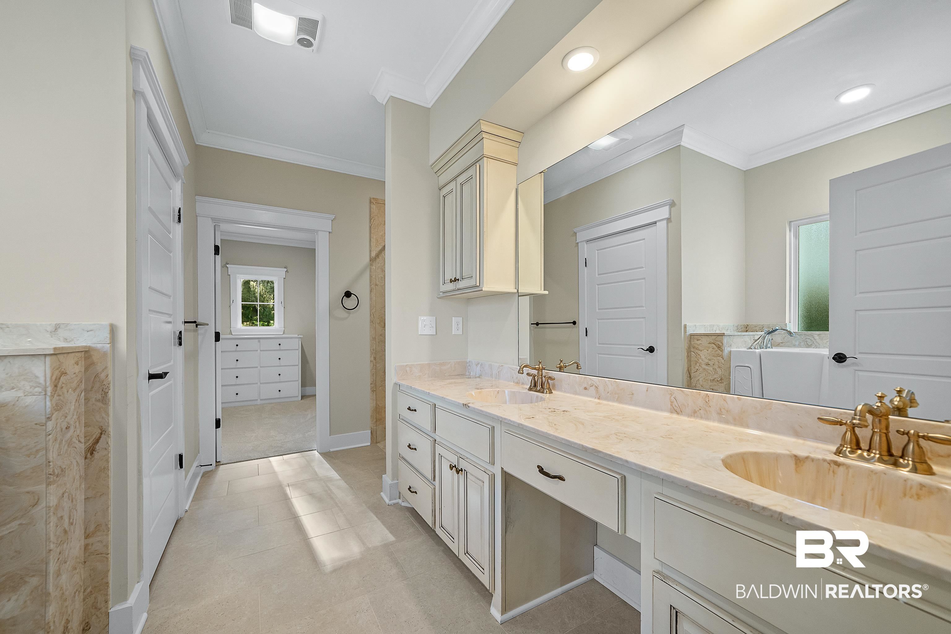 356 Liberty Street Fairhope, AL 36532 - Photo 14 of 39 Bathroom featuring crown molding, double vanity, a tub to relax in, recessed lighting, and light tile patterned floors