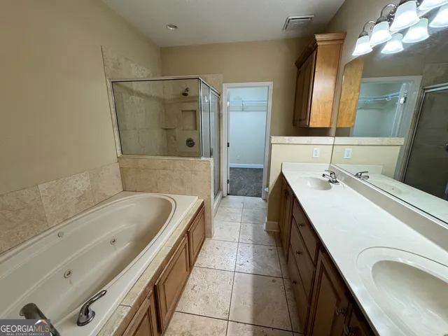 a bathroom with a sink double vanity and a mirror