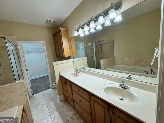 a bathroom with a mirror and a shower