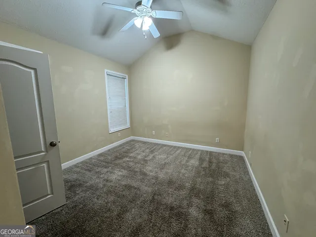 a bathroom with a sink a toilet a mirror and shower