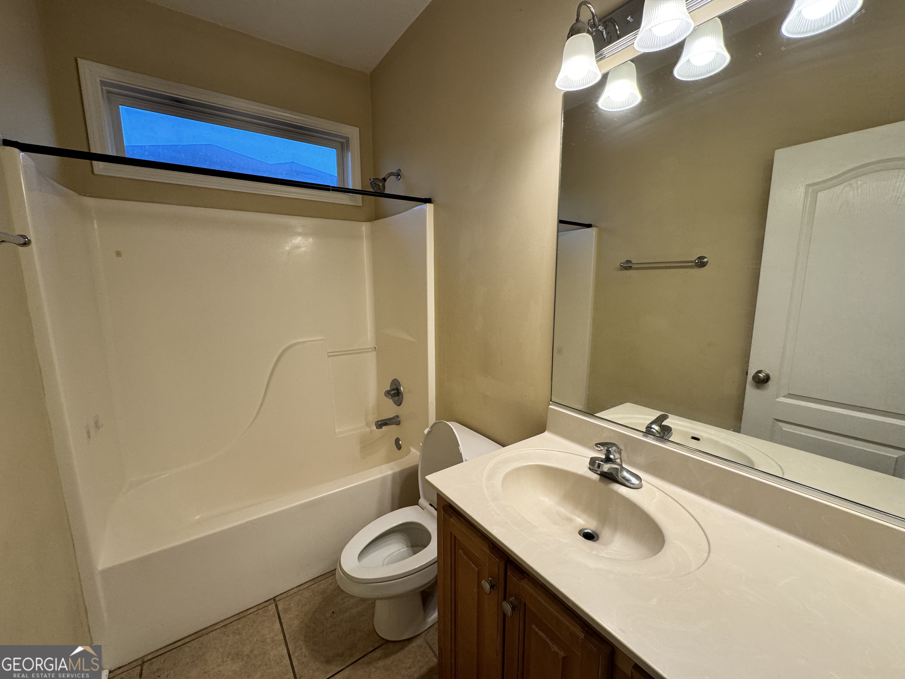 217 Austin Ryan Drive Kingsland, GA 31548 - Photo 21 of 26 a bathroom with a sink a toilet a mirror and shower