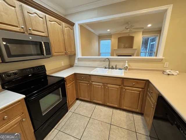 a kitchen with a sink stove and microwave