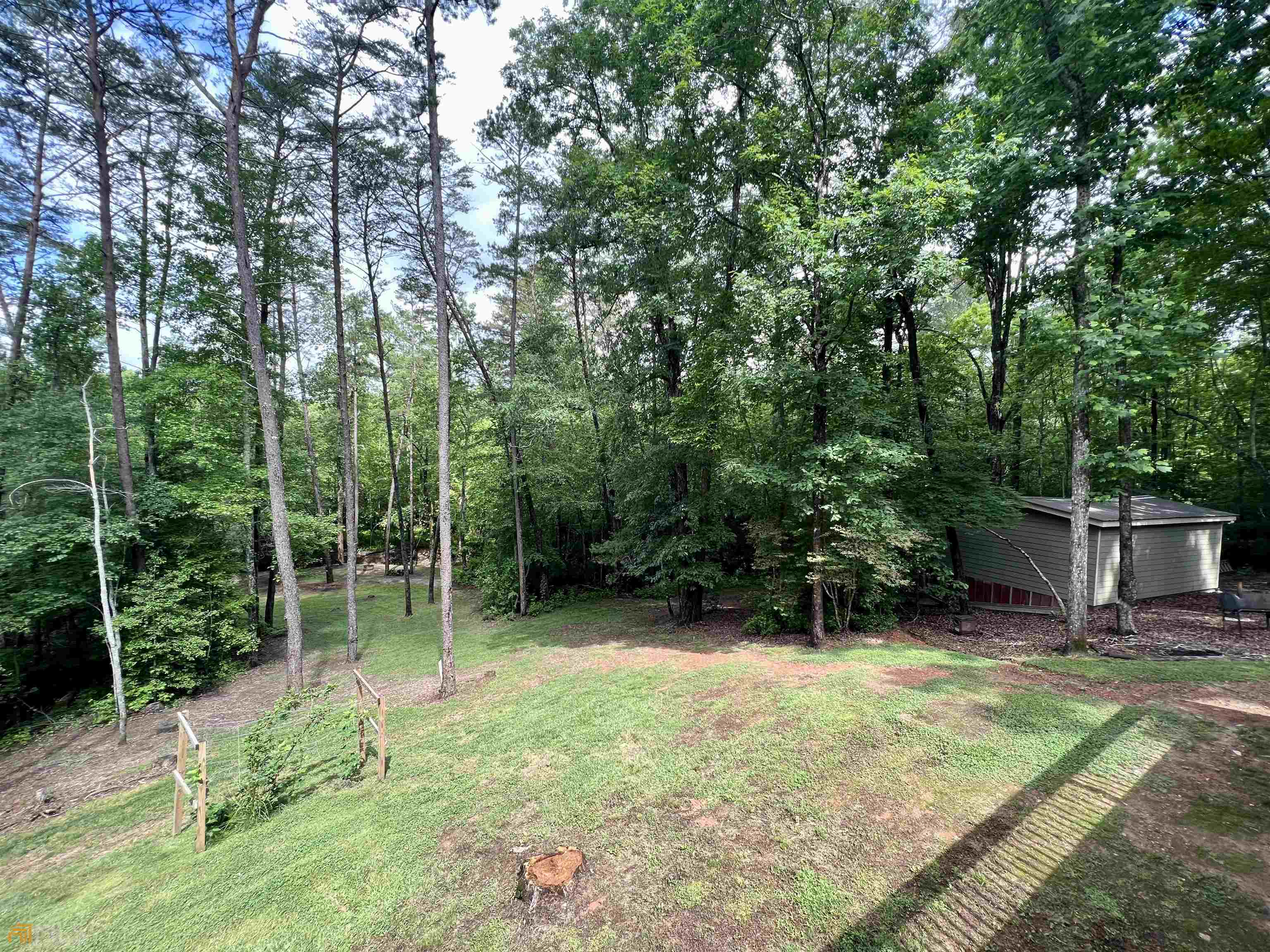 186 Holly Lane Cleveland, GA 30528 - Photo 23 of 58 a view of a chair and tables in the back yard