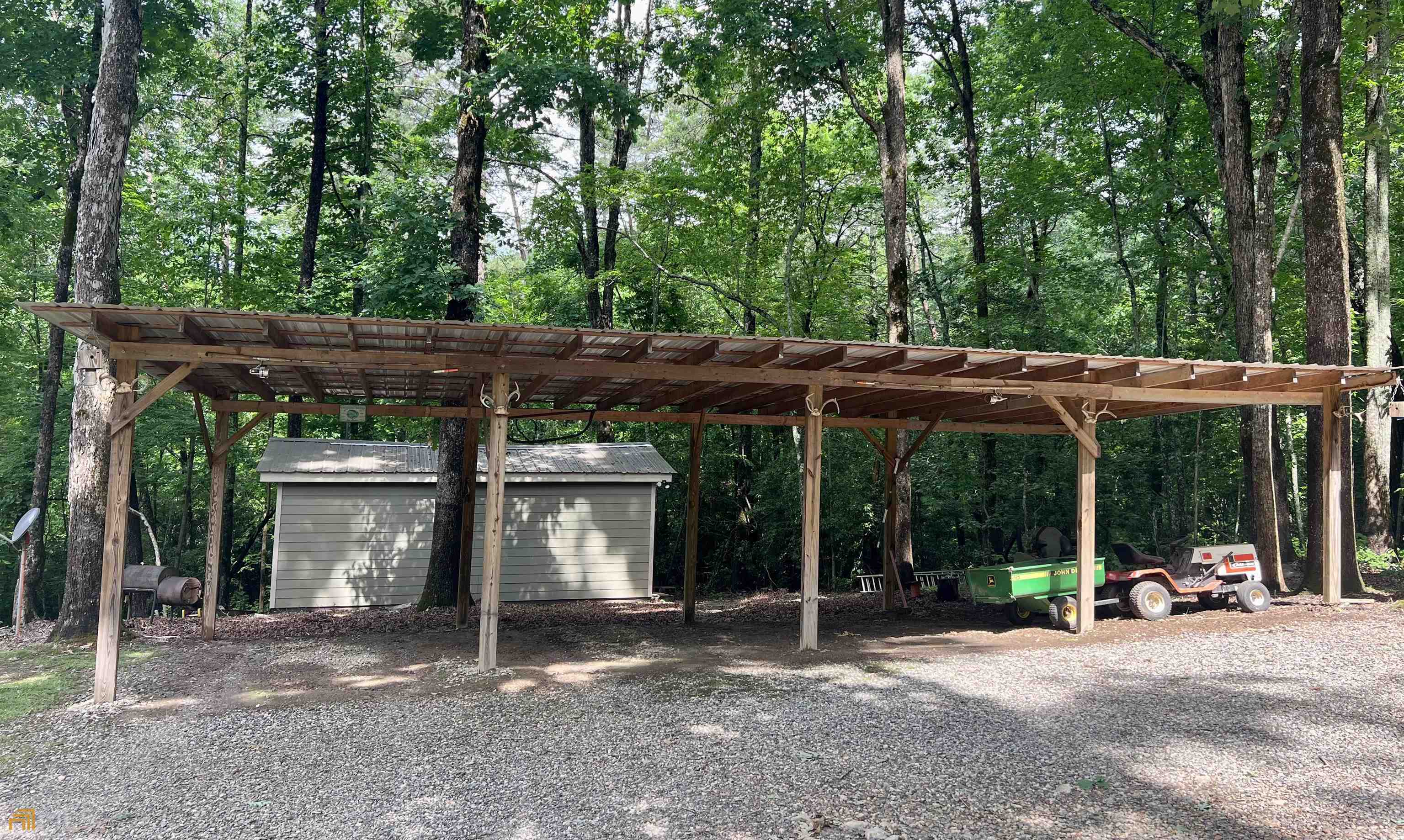 186 Holly Lane Cleveland, GA 30528 - Photo 29 of 58 a view of a patio with table and chairs under an umbrella