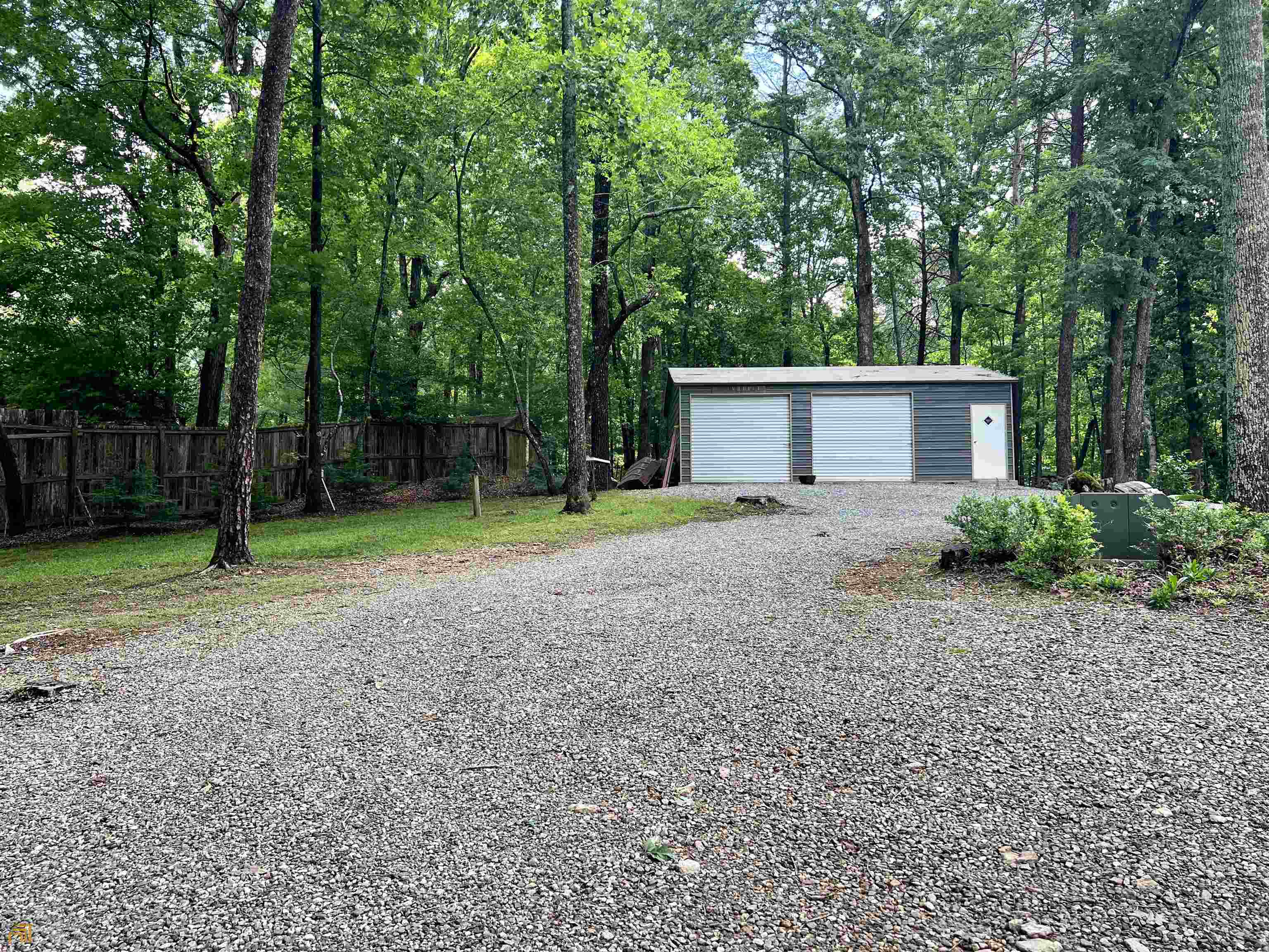 186 Holly Lane Cleveland, GA 30528 - Photo 30 of 58 a front view of a house with garden and trees