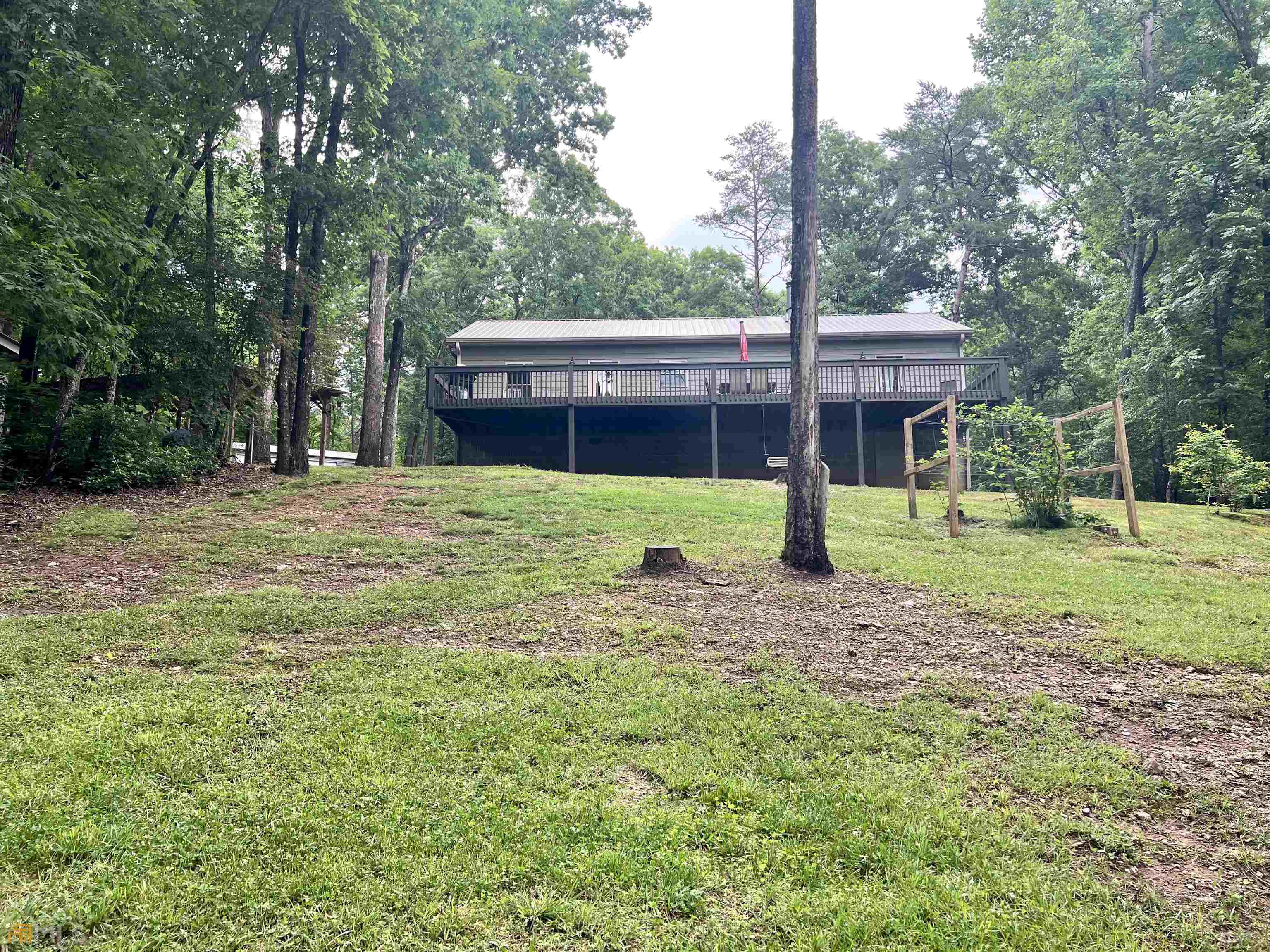 186 Holly Lane Cleveland, GA 30528 - Photo 41 of 58 a view of a house with backyard and trees