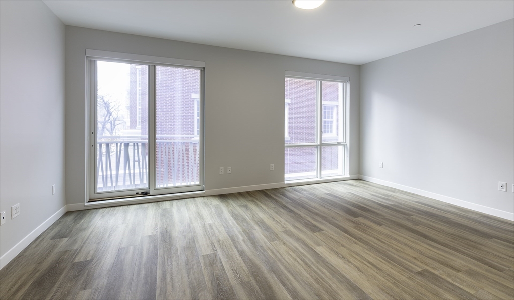 50 Rogers Street, Unit 415 Cambridge, MA 02142 - Photo 1 of 15 a view of an empty room with wooden floor and a window