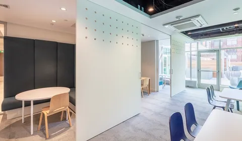 a living room with furniture a large window and chairs