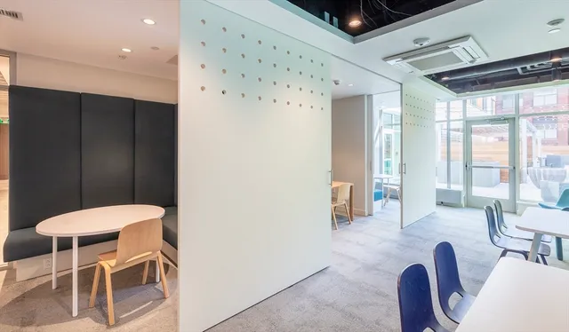 a living room with furniture a large window and chairs