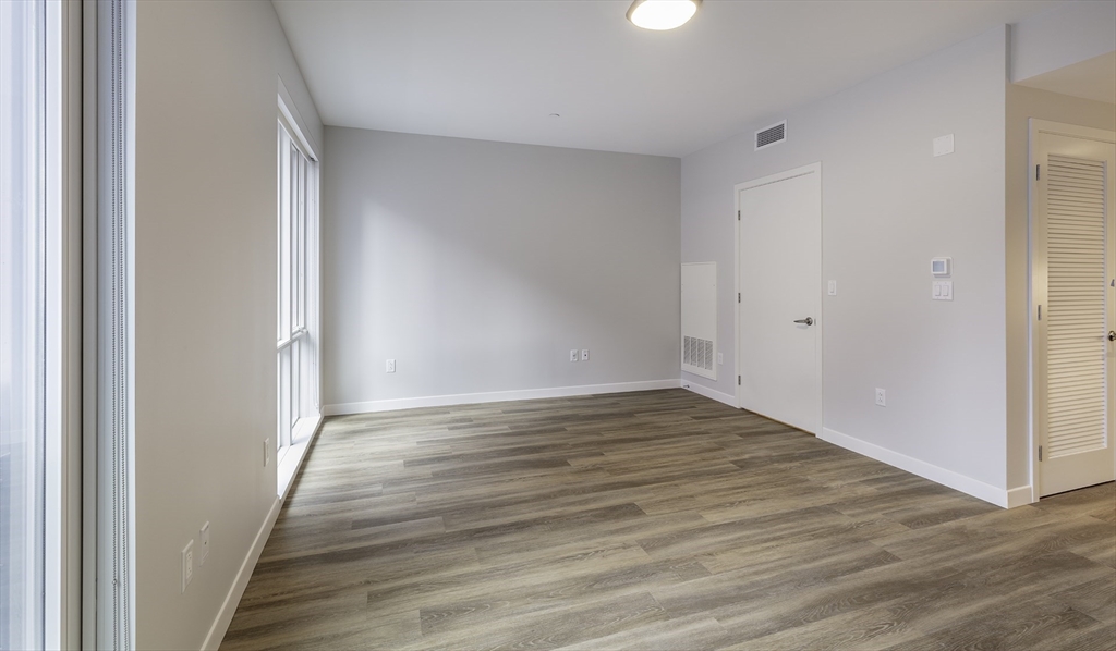 50 Rogers Street, Unit 415 Cambridge, MA 02142 - Photo 2 of 15 a view of an empty room with wooden floor