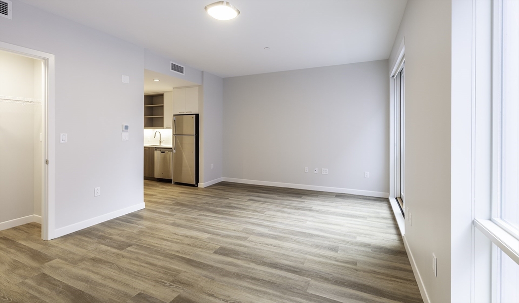 50 Rogers Street, Unit 415 Cambridge, MA 02142 - Photo 5 of 15 a view of empty room with wooden floor