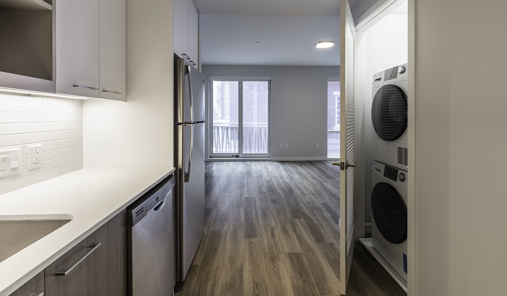 50 Rogers Street, Unit 415 Cambridge, MA 02142 - Photo 6 of 15 a view of hallway with washer and dryer