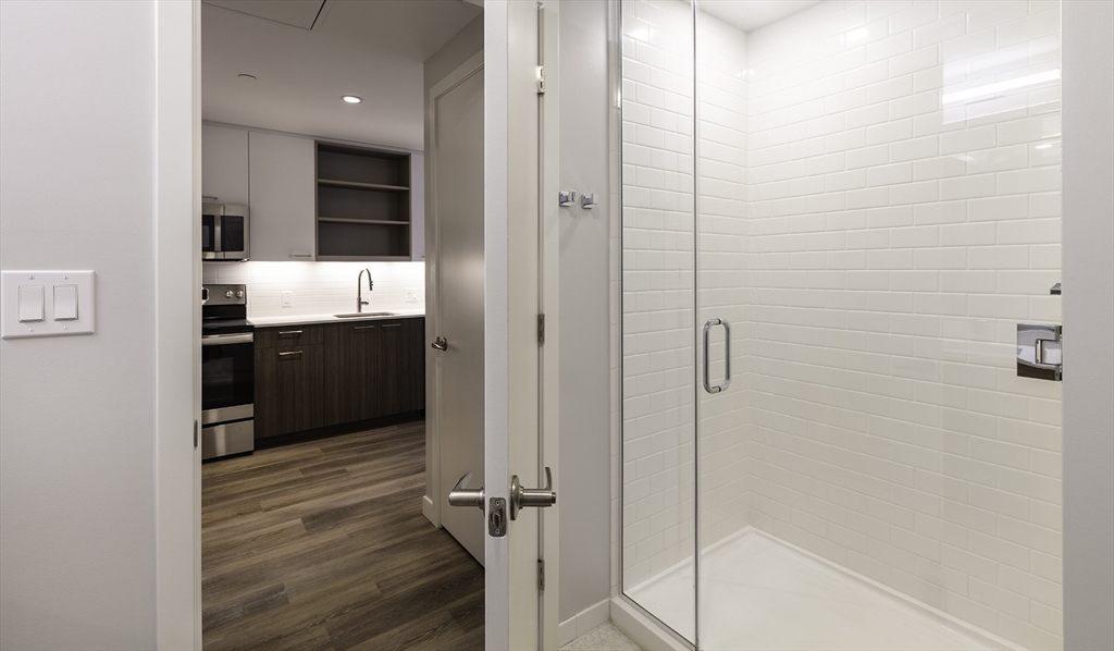 50 Rogers Street, Unit 415 Cambridge, MA 02142 - Photo 7 of 15 a bathroom with a sink and mirror
