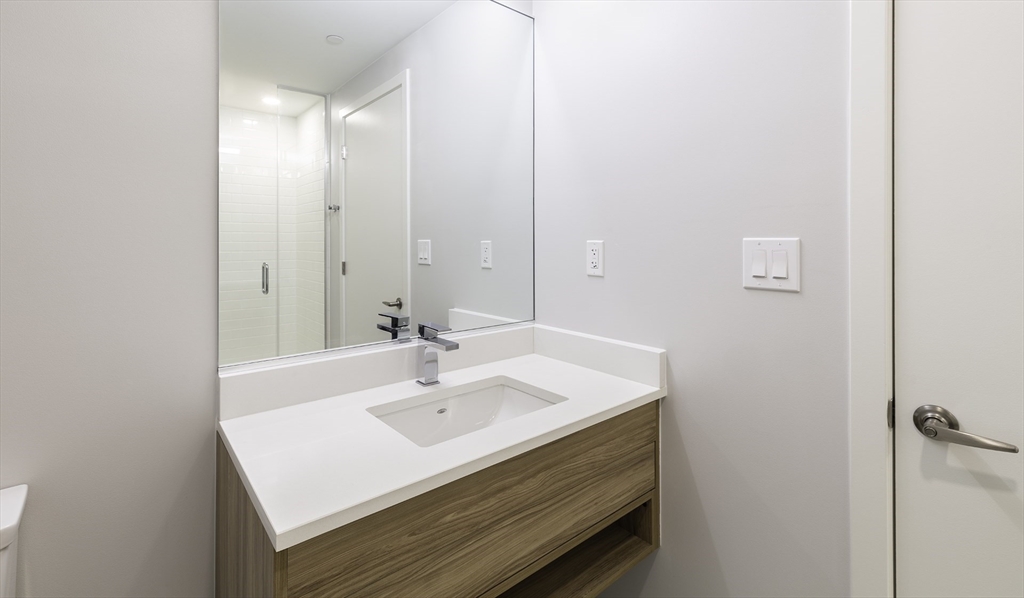 50 Rogers Street, Unit 415 Cambridge, MA 02142 - Photo 8 of 15 a bathroom with a sink and a mirror