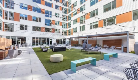 a view of a swimming pool with outdoor seating
