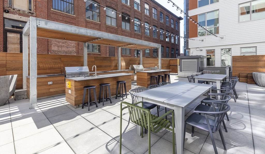 50 Rogers Street, Unit 415 Cambridge, MA 02142 - Photo 10 of 15 a patio with a table and chairs