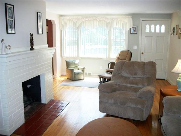 398 Plumtree Road Springfield, MA 01118 - Photo 2 of 24 a living room with furniture a large window and a fireplace