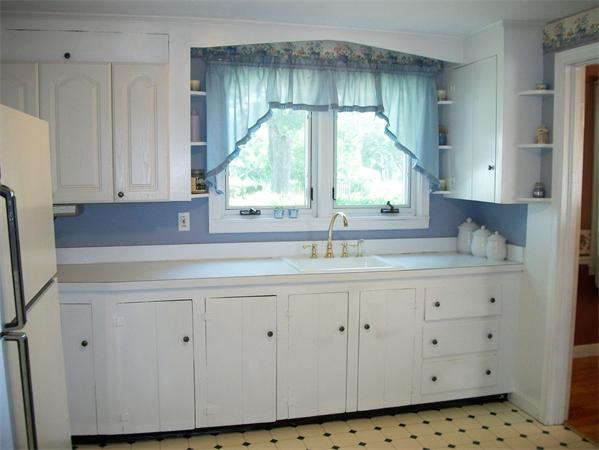 398 Plumtree Road Springfield, MA 01118 - Photo 4 of 24 a kitchen with white cabinets a window and a sink
