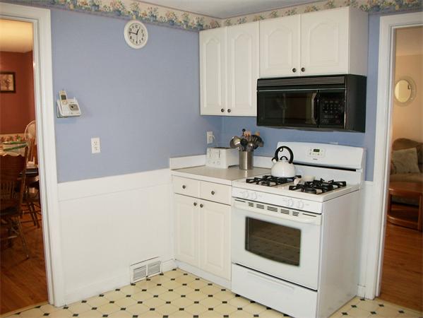 398 Plumtree Road Springfield, MA 01118 - Photo 5 of 24 a kitchen with a stove and a microwave