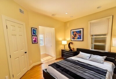 207 Princeton Street, Unit 2 Boston, MA 02128 - Photo 5 of 12 a bedroom with a bed and wooden floor