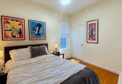 207 Princeton Street, Unit 2 Boston, MA 02128 - Photo 6 of 12 a bedroom with bed and painting on the wall