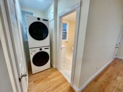 207 Princeton Street, Unit 2 Boston, MA 02128 - Photo 10 of 12 a view of a hallway with washer and dryer