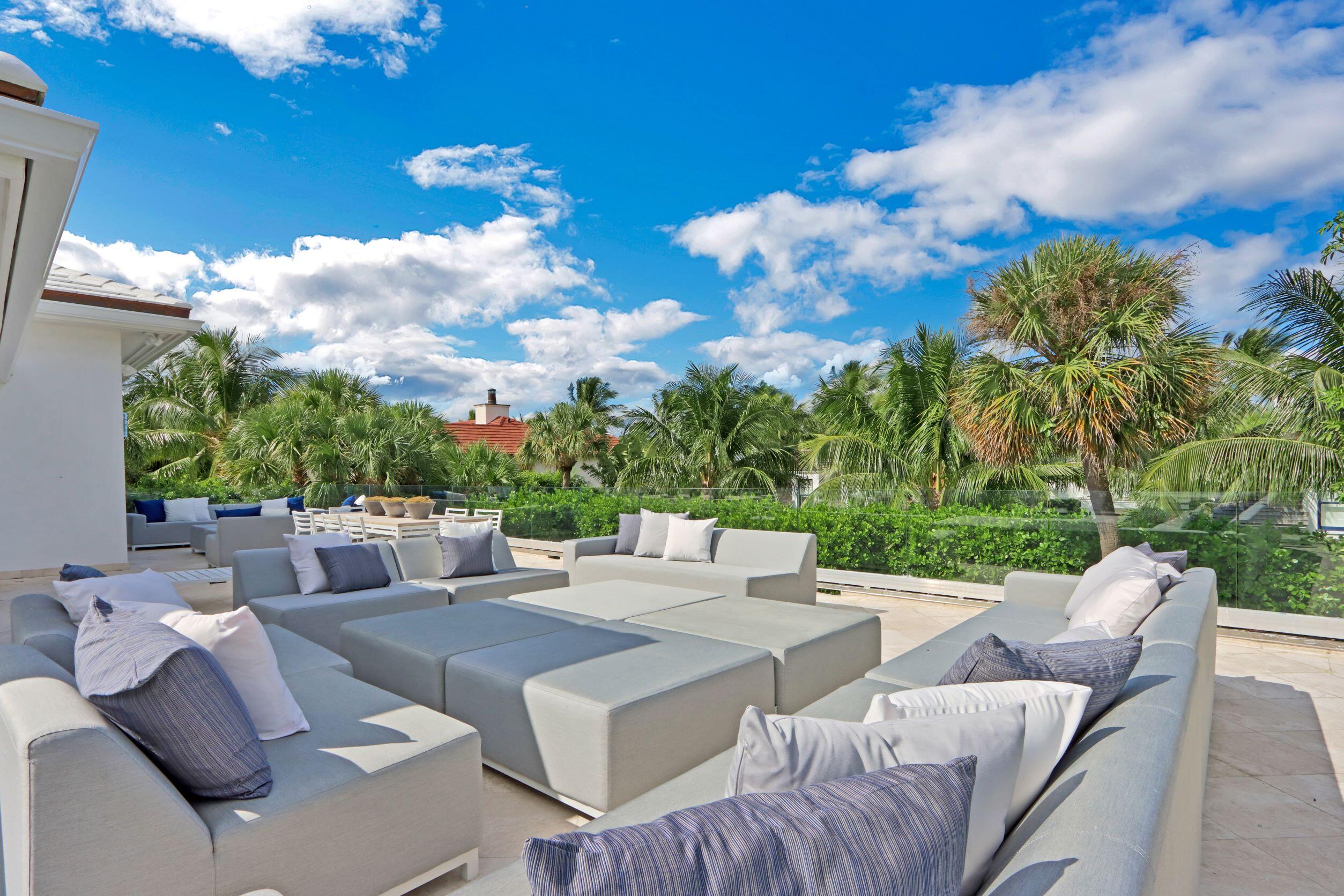 215 Indian Road Palm Beach, FL 33480 - Photo 14 of 33 a view of a patio with couches table and chairs and potted plants