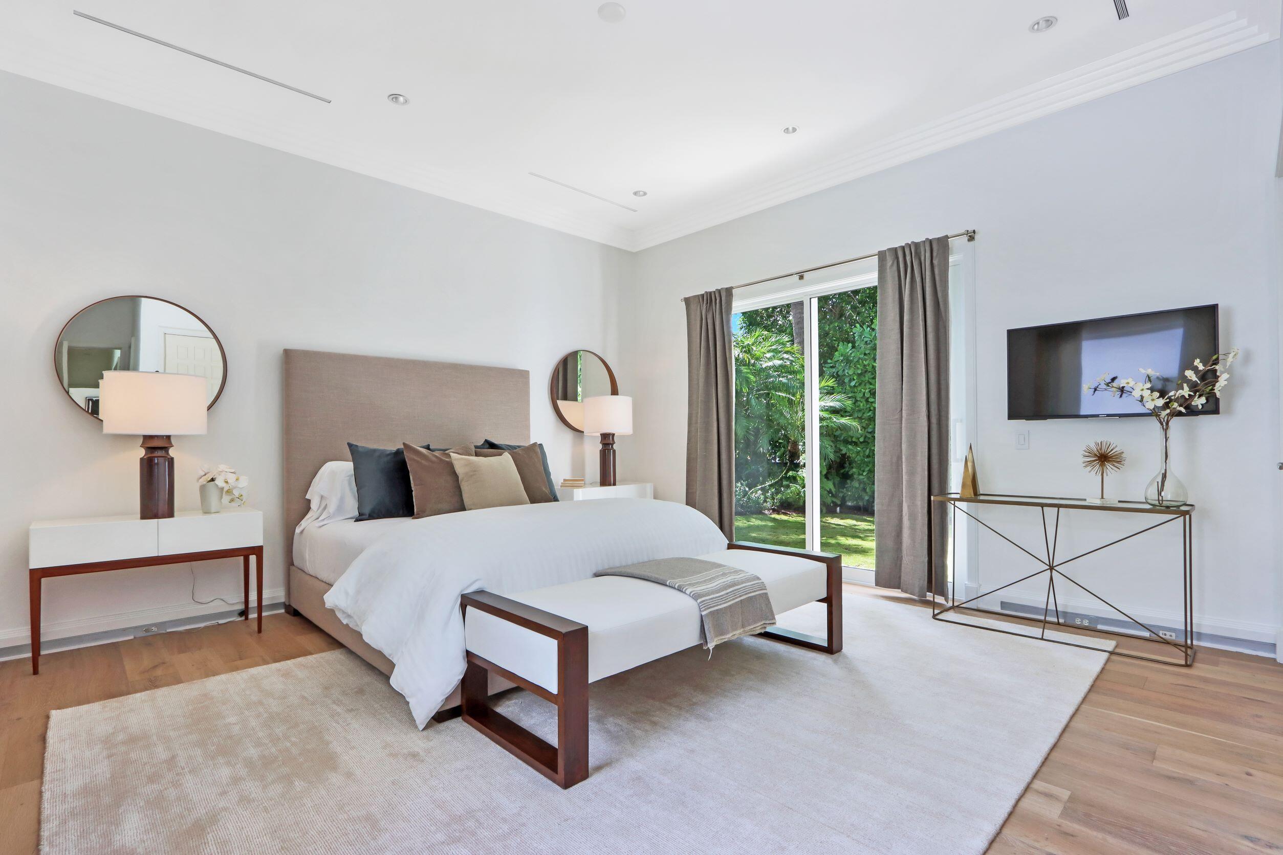 215 Indian Road Palm Beach, FL 33480 - Photo 15 of 33 a bedroom with a bed a mirror and window