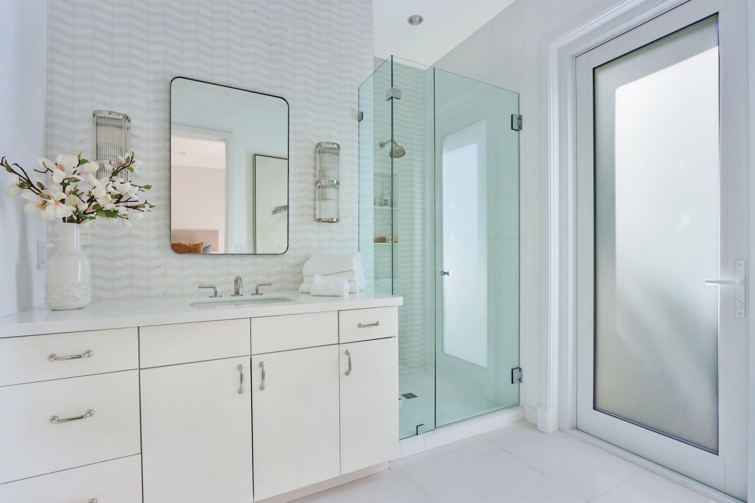 215 Indian Road Palm Beach, FL 33480 - Photo 19 of 33 a bathroom with a shower sink and mirror