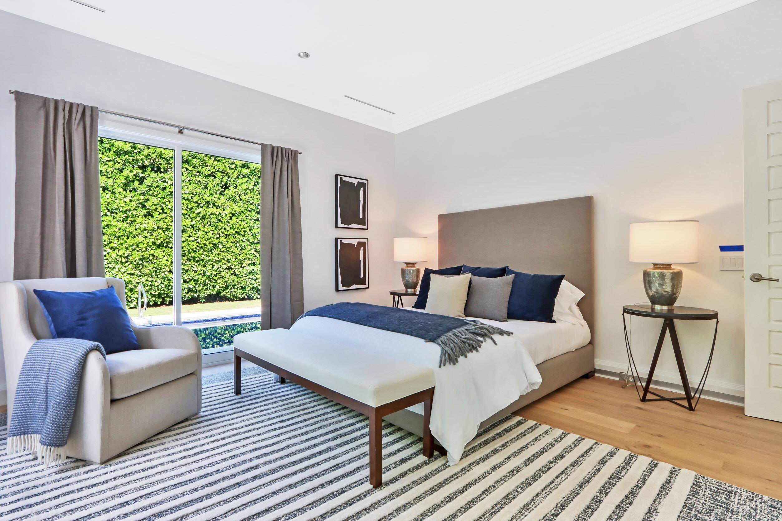 215 Indian Road Palm Beach, FL 33480 - Photo 23 of 33 a spacious bedroom with a bed couch and a window