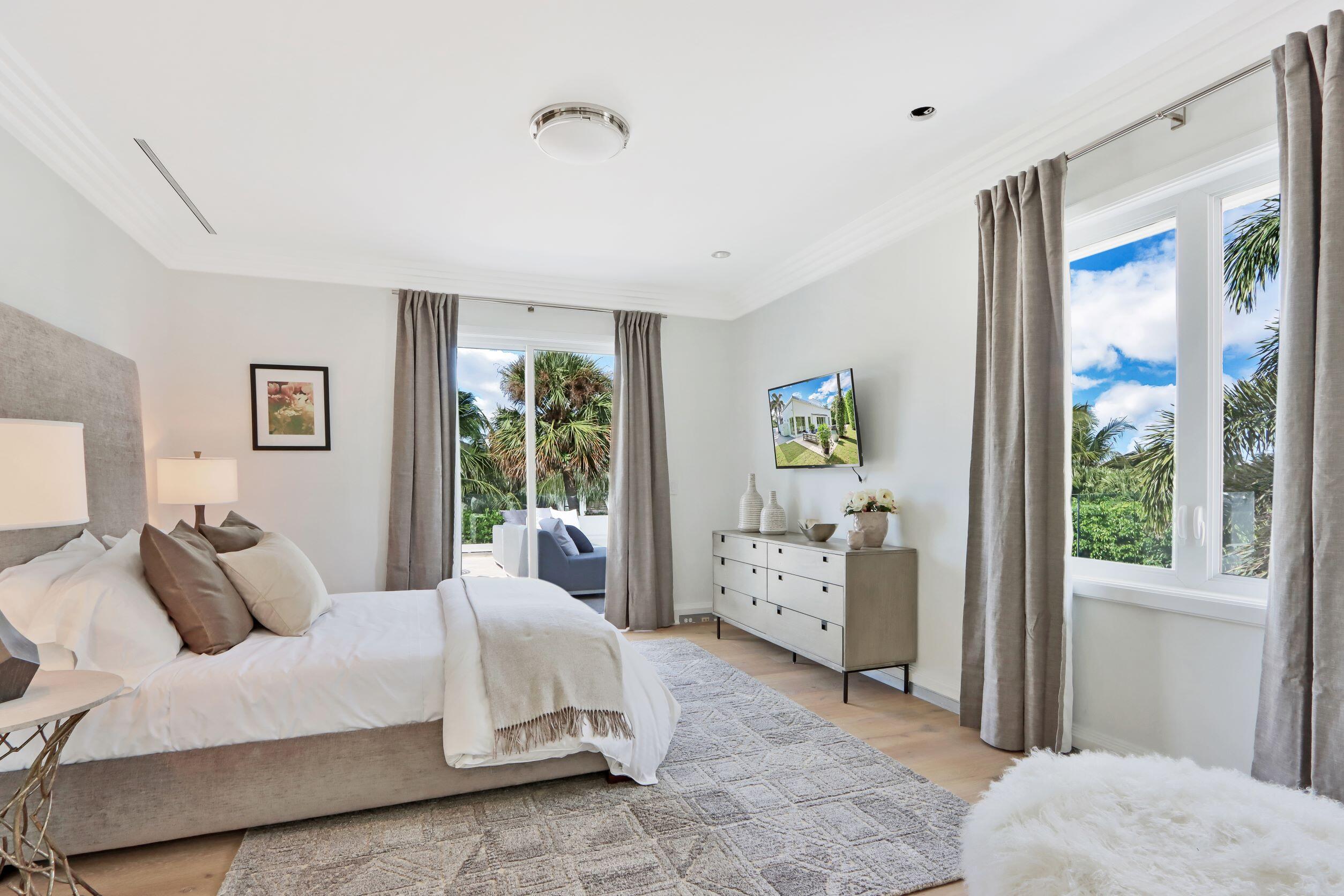 215 Indian Road Palm Beach, FL 33480 - Photo 24 of 33 a spacious bedroom with a bed and large windows