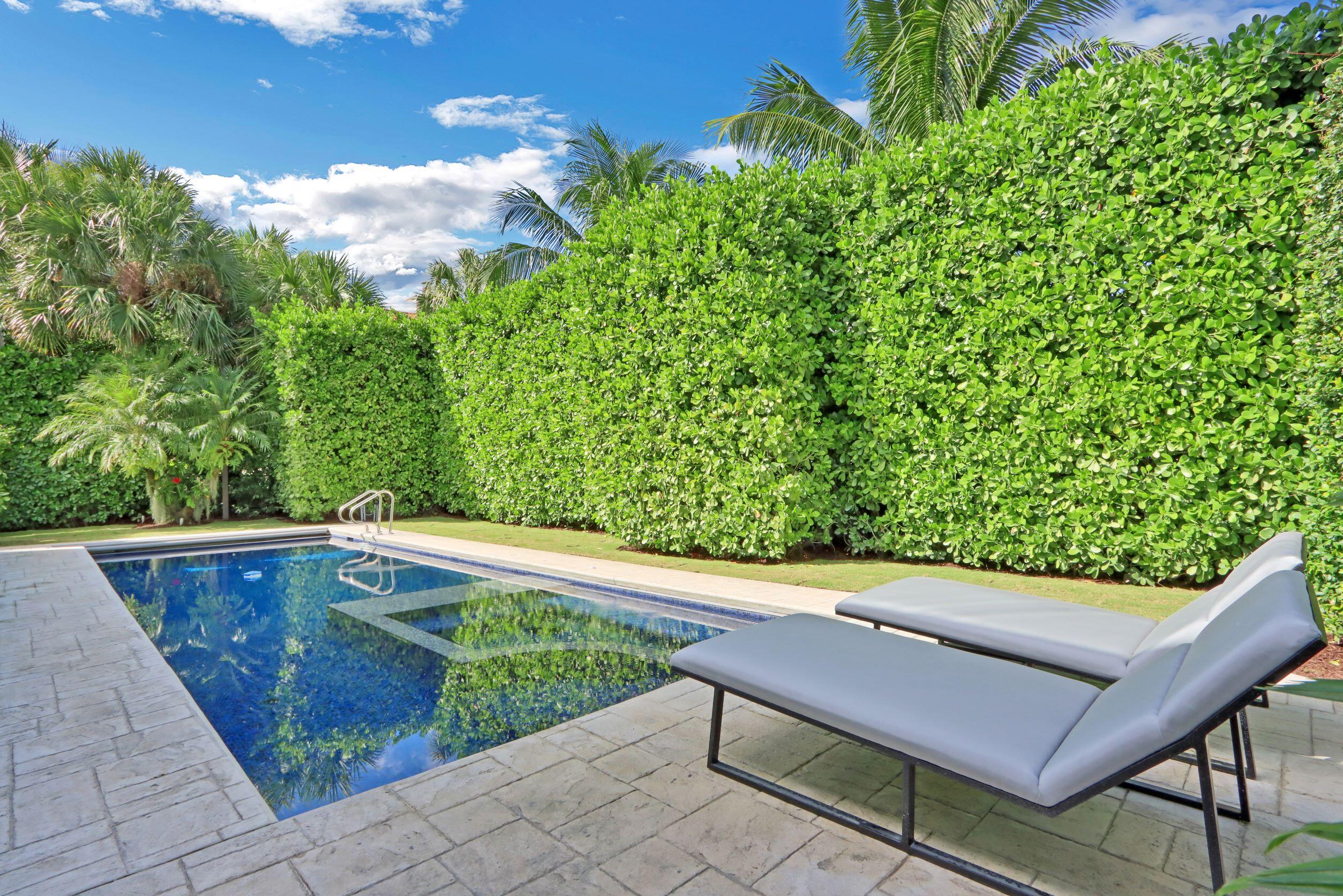 215 Indian Road Palm Beach, FL 33480 - Photo 30 of 33 a wooden bench sitting in a backyard of a house