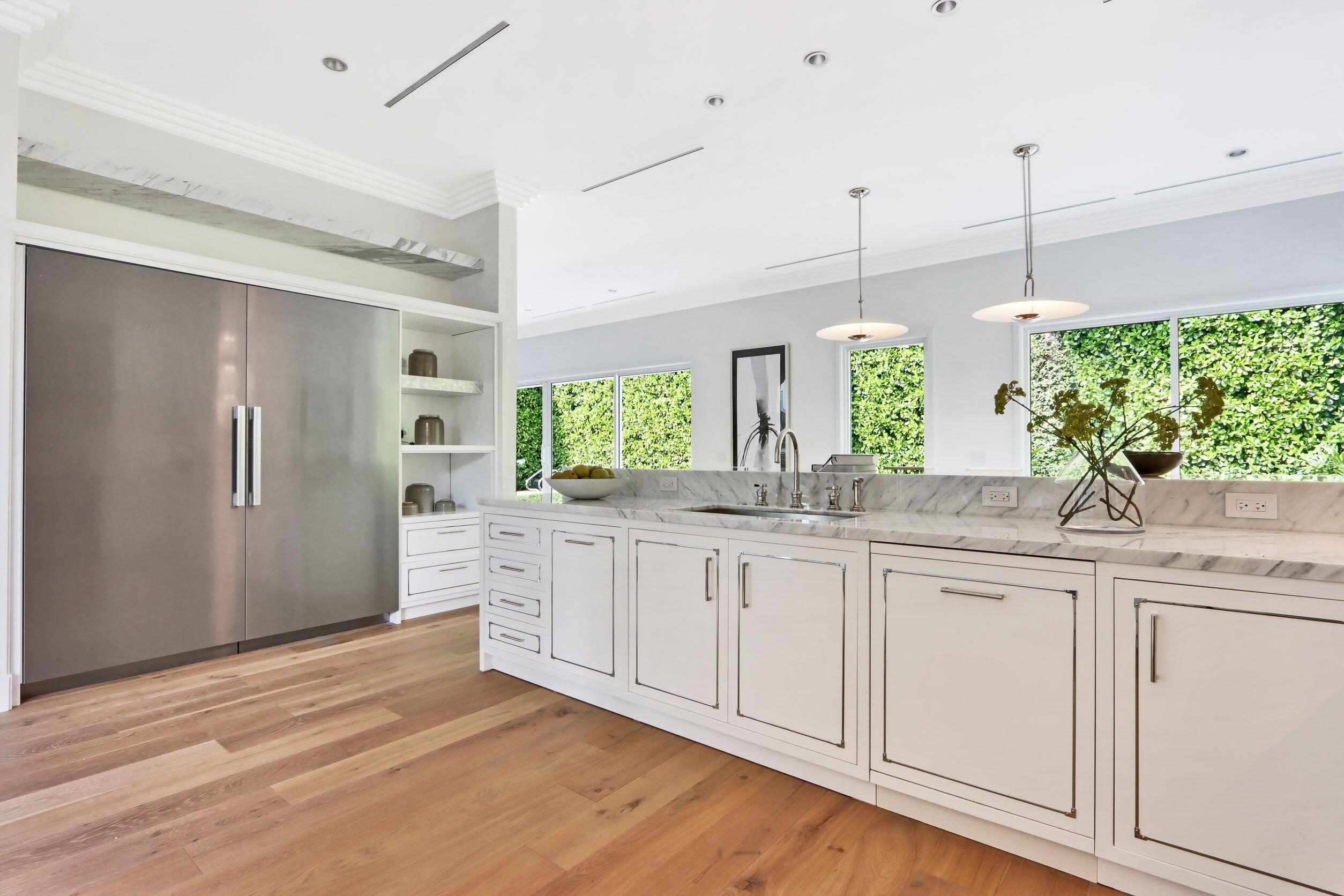 215 Indian Road Palm Beach, FL 33480 - Photo 6 of 33 a kitchen with granite countertop white cabinets and white appliances