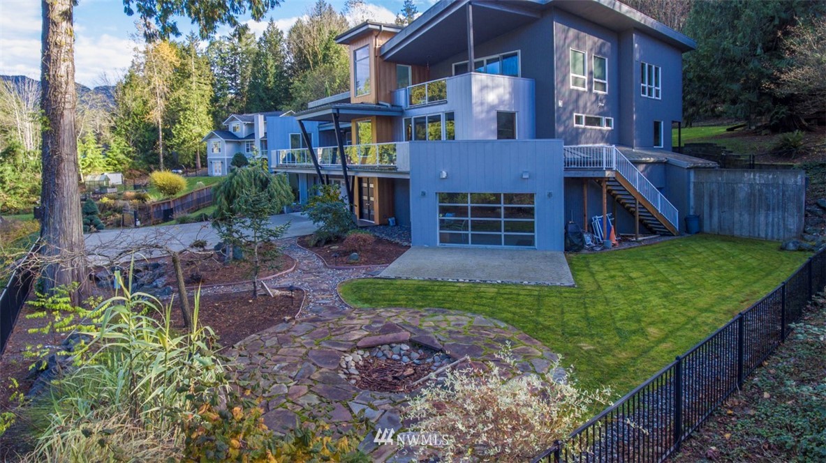 a view of a brick house with a yard and plants