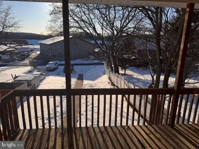 a view of a balcony with a floor to ceiling window and wooden floor