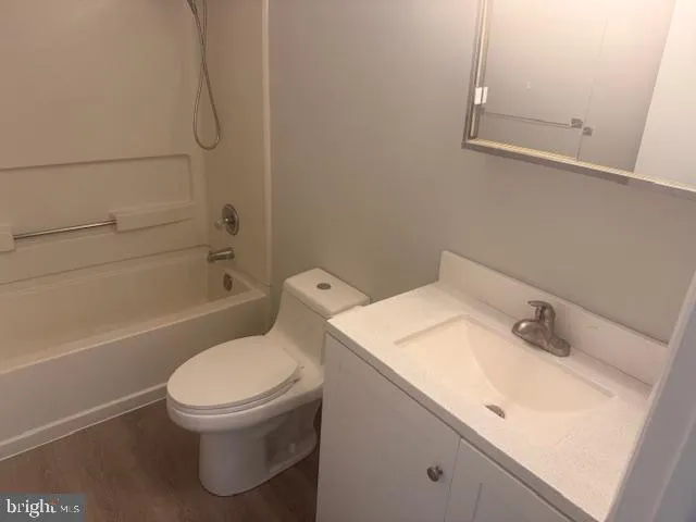 a white toilet sitting next to a bath tub