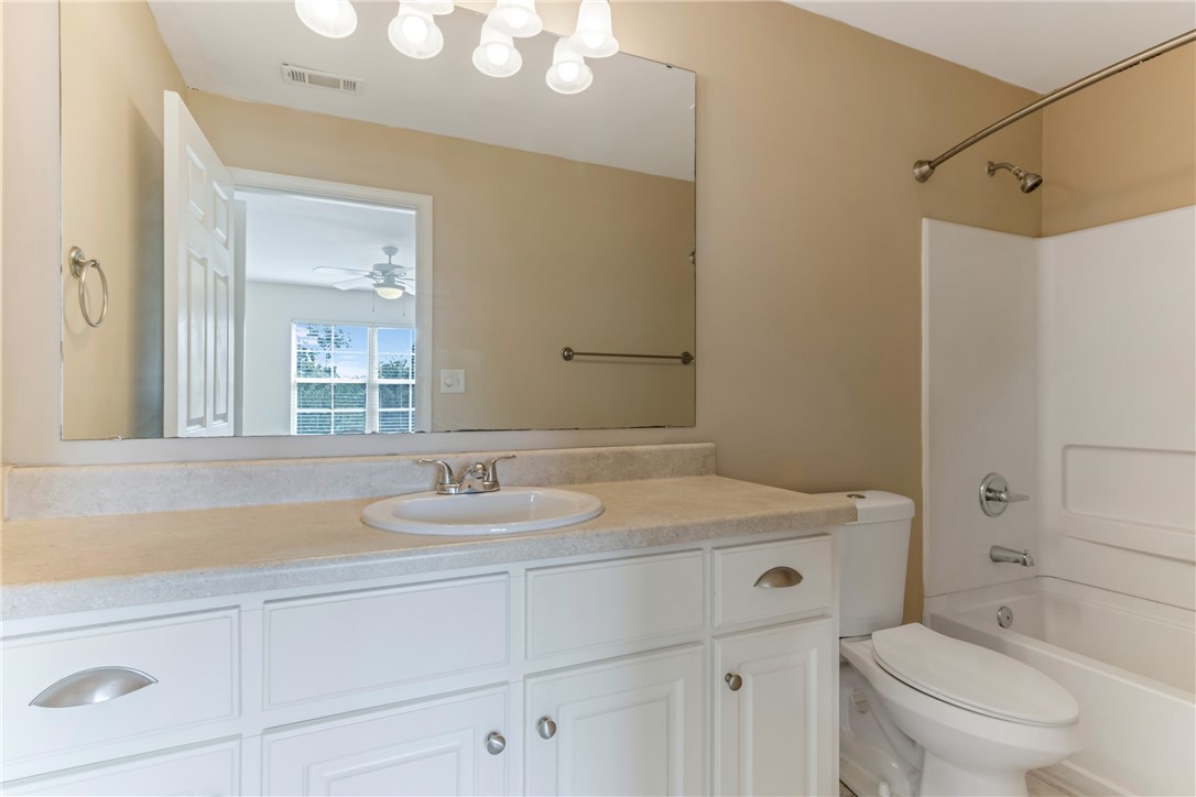 725 Lookover Drive Anderson, SC 29621 - Photo 11 of 31 White cabinetry paired with a large vanity mirror anchors this classic, functional bathroom space.