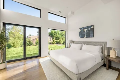 a spacious bathroom with a double vanity sink mirror and bathtub