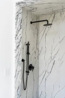 a large bedroom with a bed and glass window