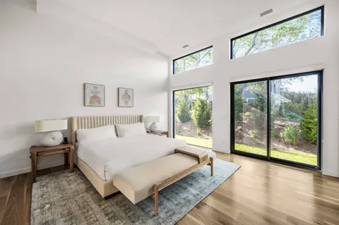 a bedroom with a large bed and a window