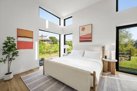 a bed room with a bed and painting on the wall